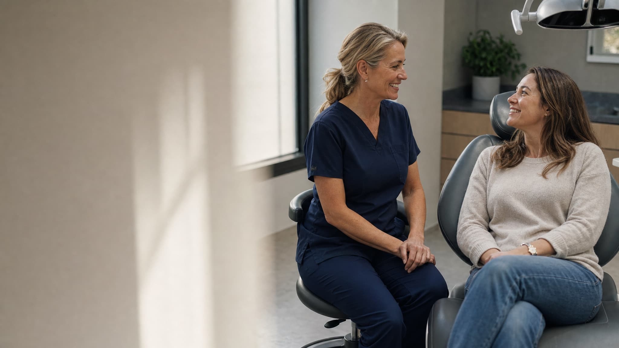 A business owner talks with a relaxed, smiling customer.